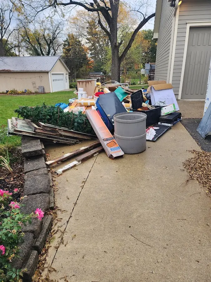 Dumpster being loaded with debris for Demolition Dumpster Rental in Macon-Bibb County